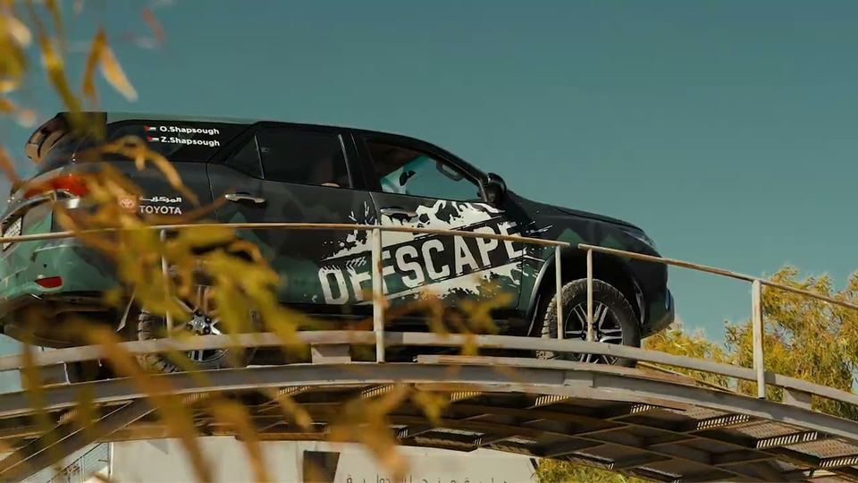 Toyota Off-Escape vehicle shot through desert foliage